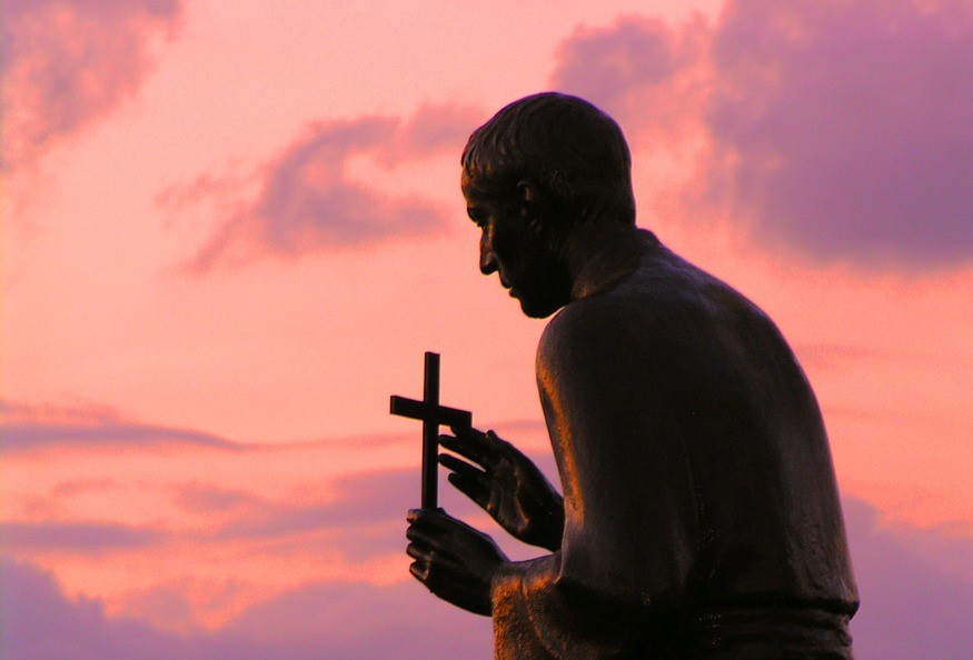 photo of state of St John Vianney with pink sky